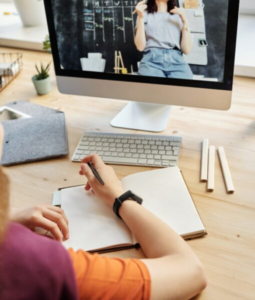 Person Using Silver Imac While Holding Pencil